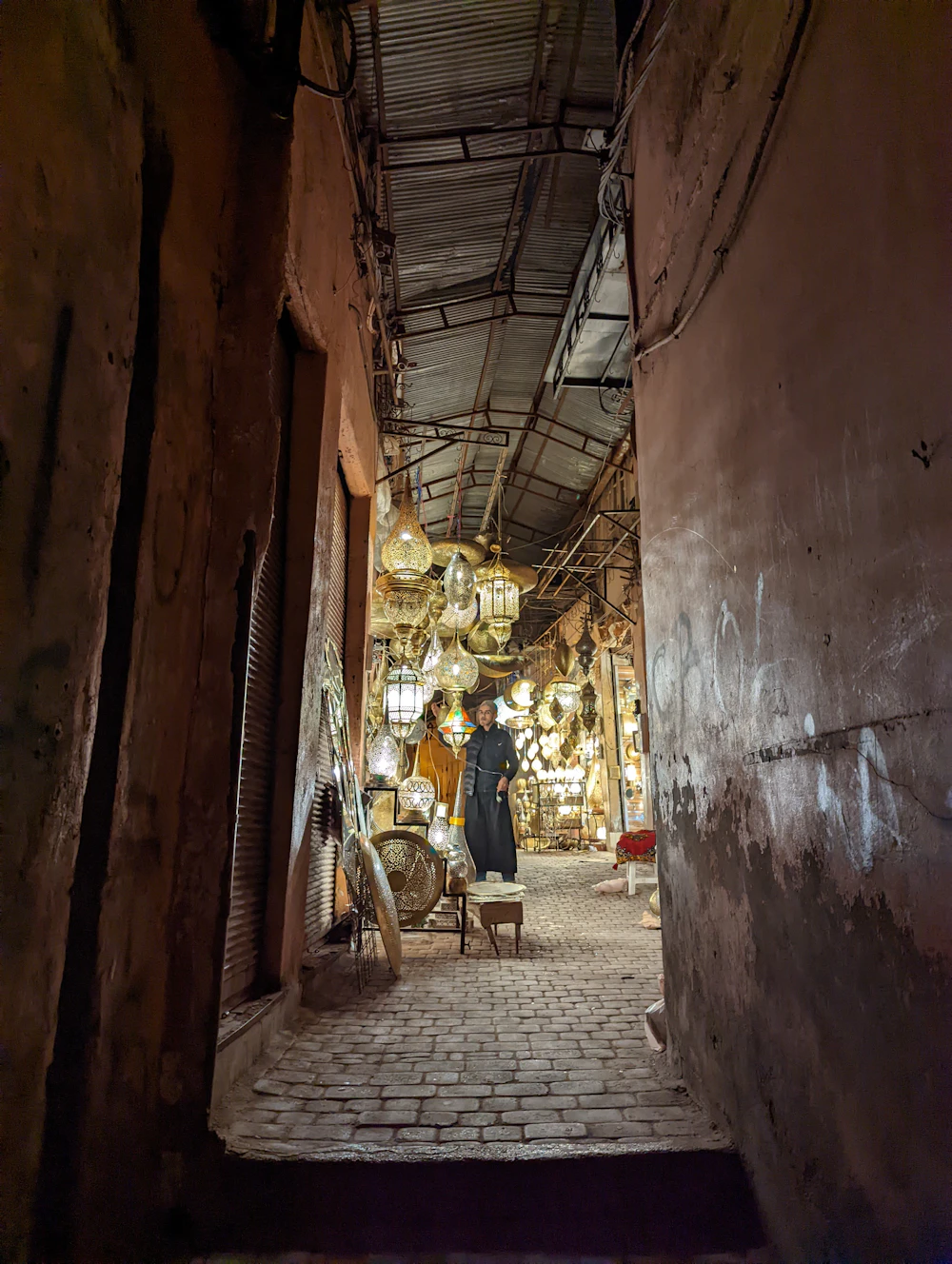 Lanterns glowing inside a narrow Marrakech medina alley